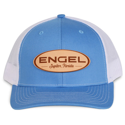A blue and white Engel Columbia Blue & White 112 Trucker Cap by Richardson®, featuring a breathable mesh back and an Engel Leather Patch on it.