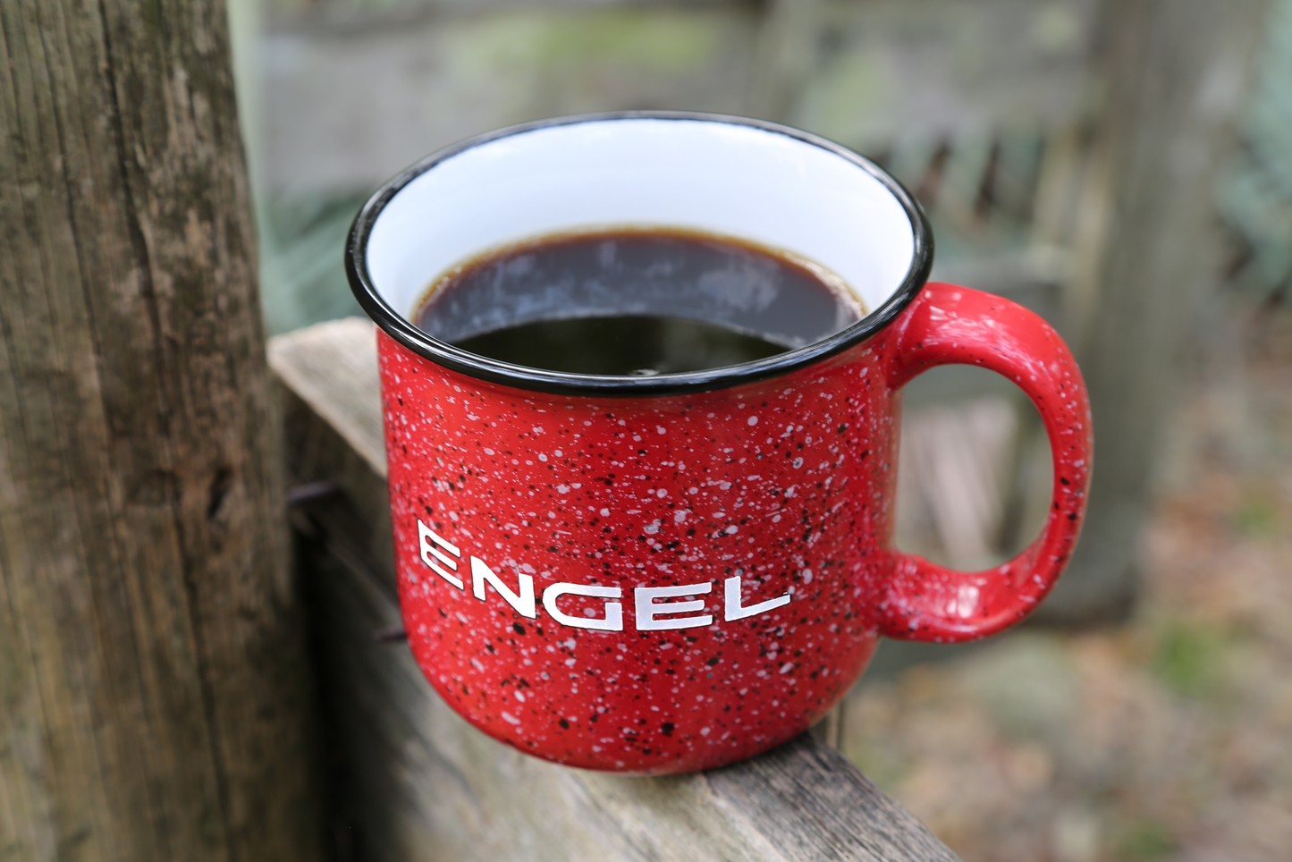 A red Old School Campfire Mug with a black rim and white text on it featuring a retro granite design from Engel Coolers.